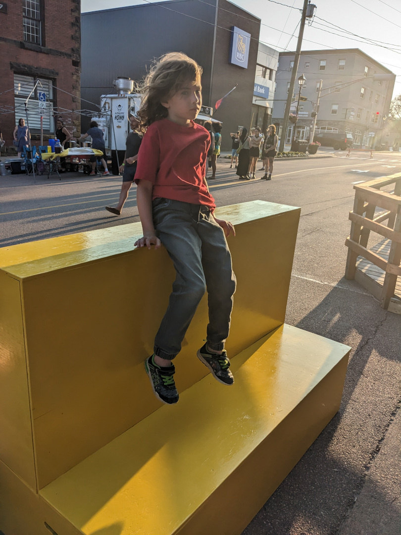 Kid sliding off the bench.